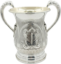 Silver natla cup with intricate designs on a white background
