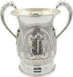 Silver natla cup with intricate designs on a white background