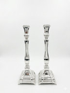 A pair of silver candlesticks with fluted stems and square bases, by hadad bros silverware