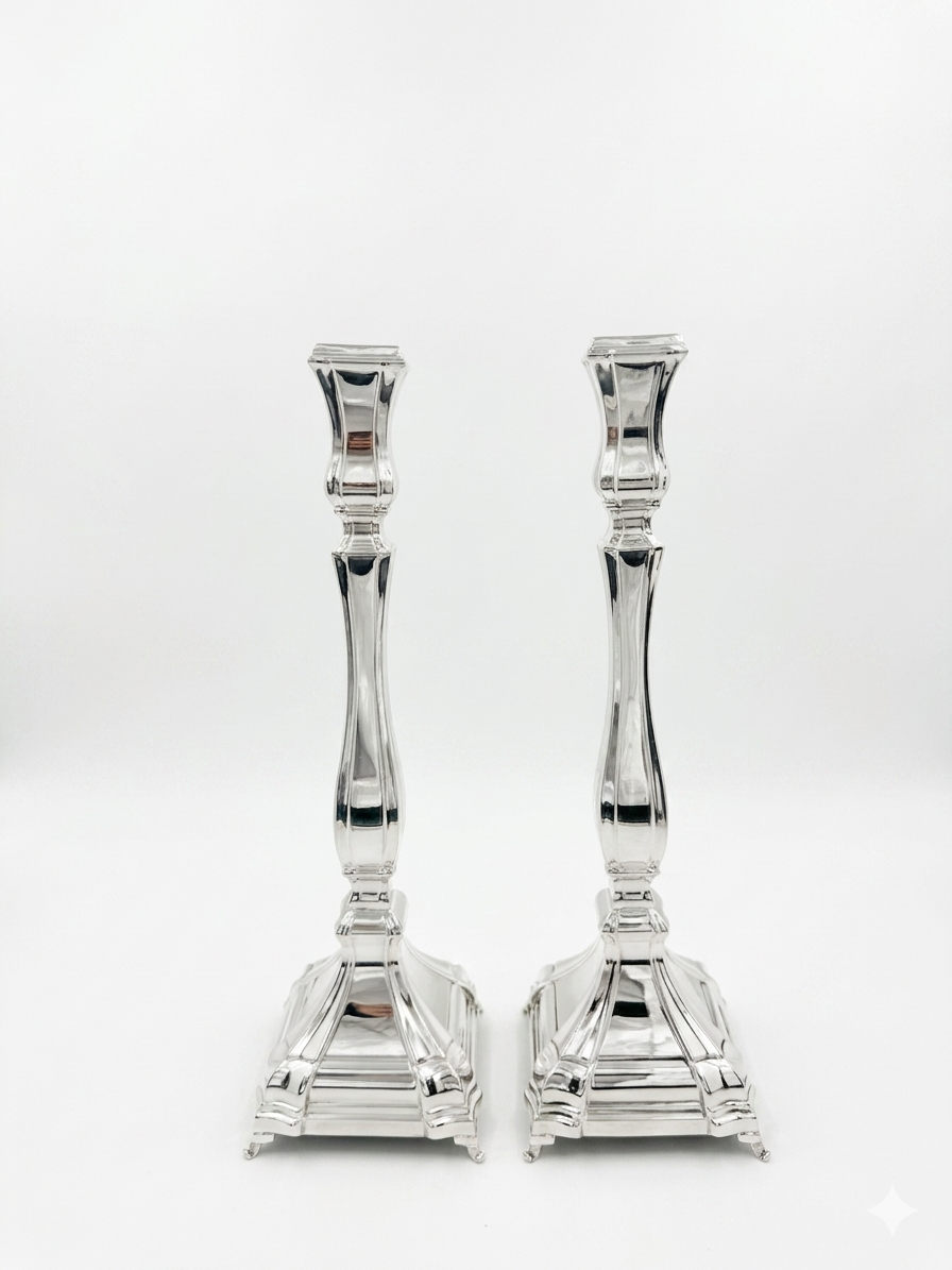 A pair of silver candlesticks with fluted stems and square bases, by hadad bros silverware