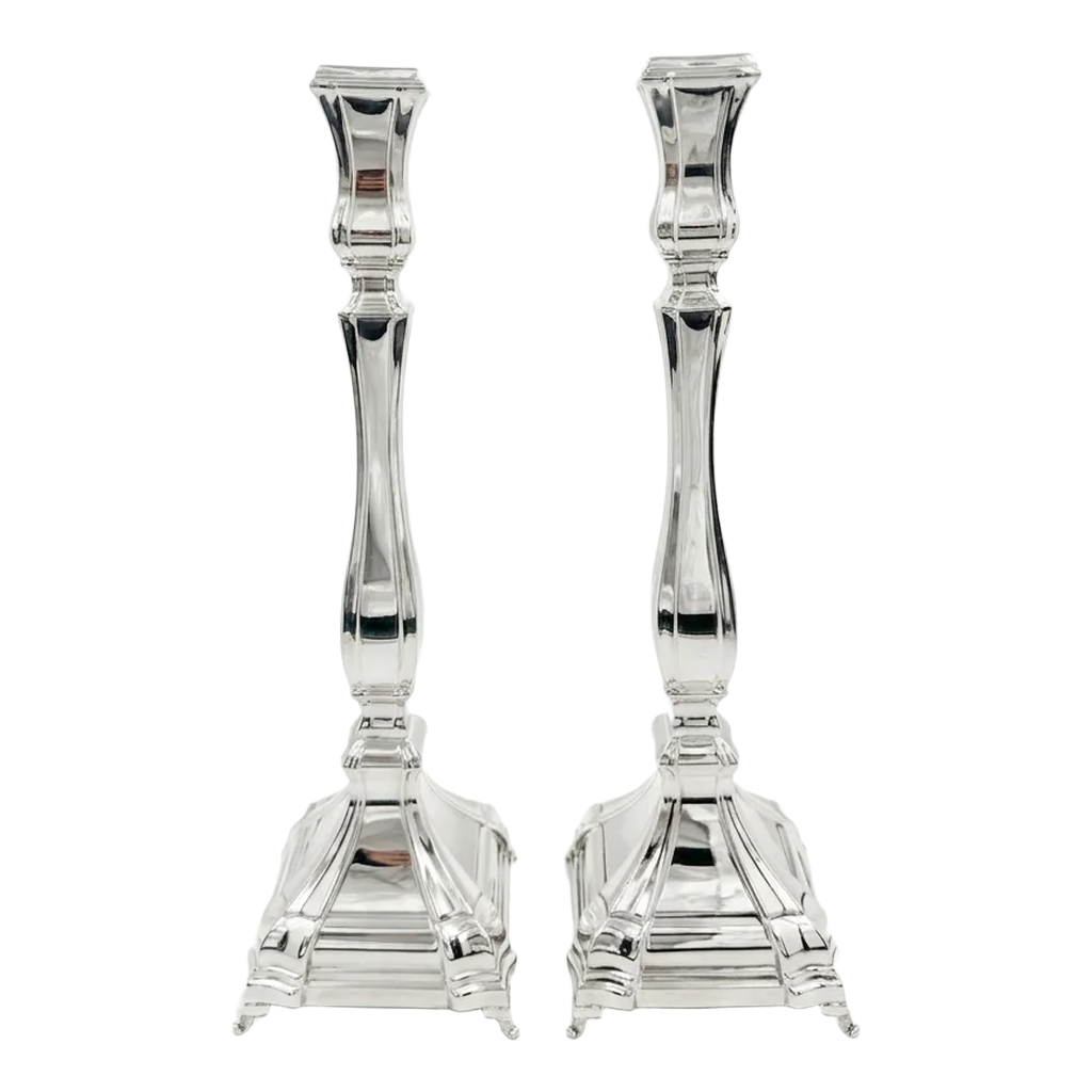A pair of silver candlesticks with fluted stems and square bases, by hadad bros silverware