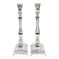 A pair of silver candlesticks with fluted stems and square bases, by hadad bros silverware