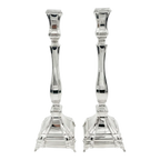 A pair of silver candlesticks with fluted stems and square bases, by hadad bros silverware