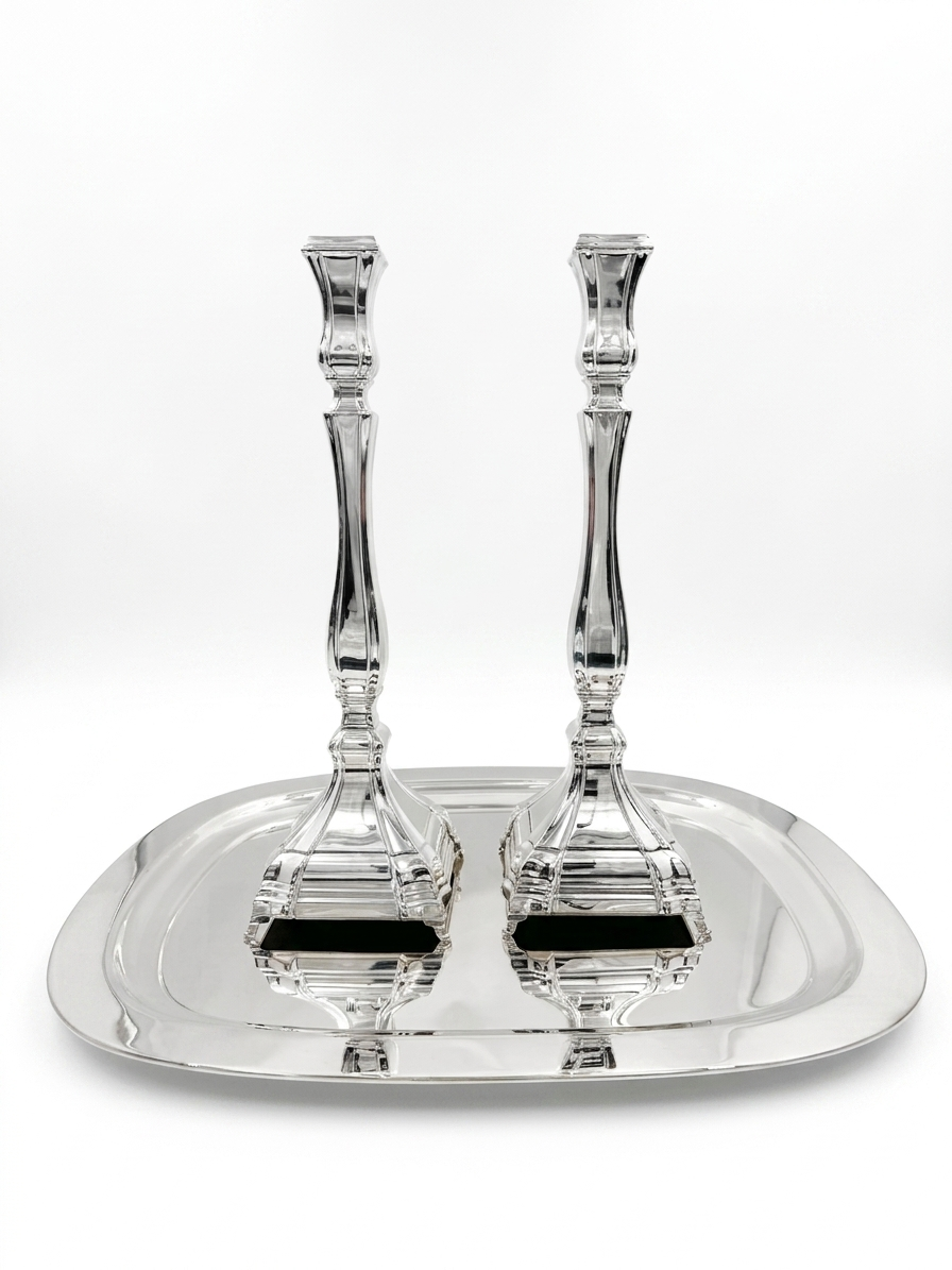 A pair of silver candlesticks with fluted stems and square bases, by hadad bros silverware
