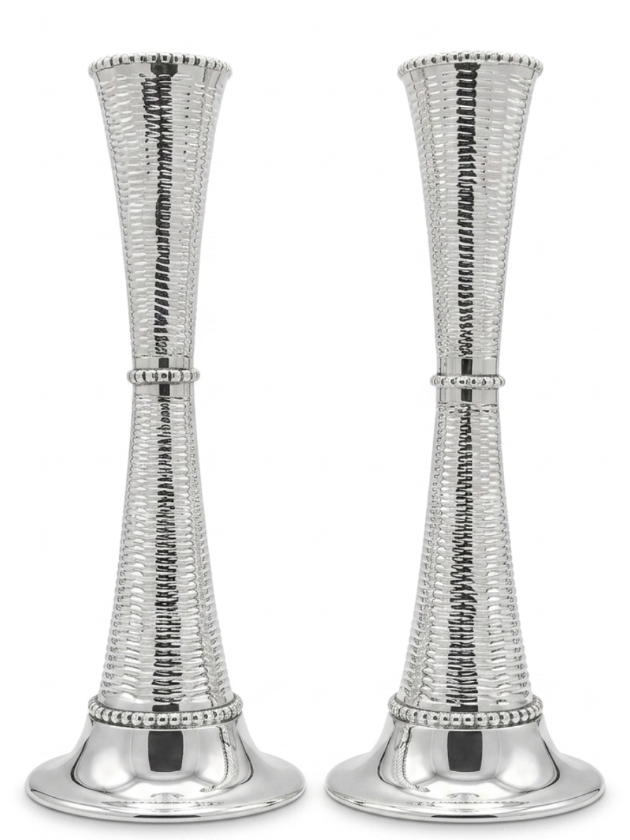 Two silver candle holders with textured design on a white background