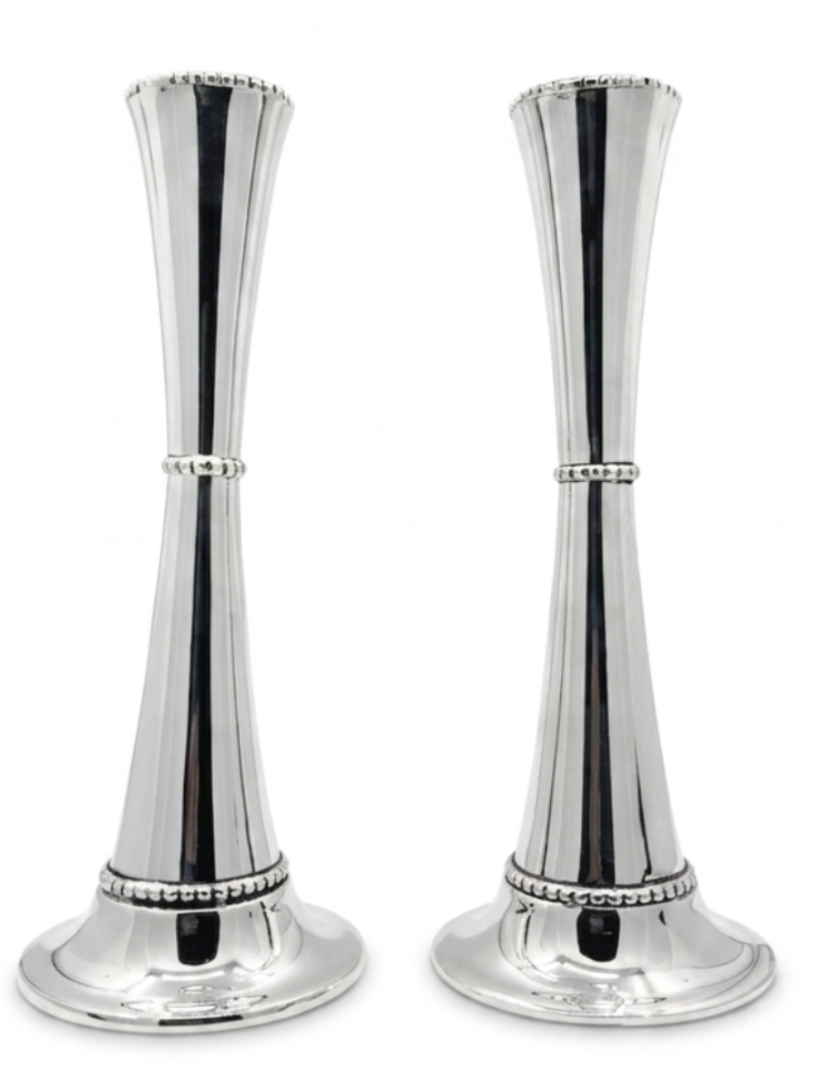 Two silver candle holders with beaded detailing on a white background