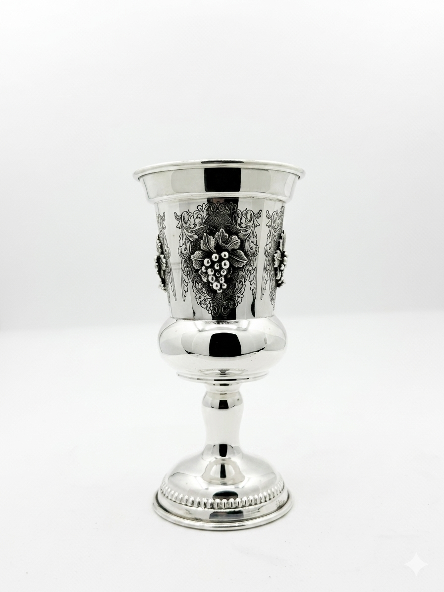 Silver goblet with intricate designs on a white background