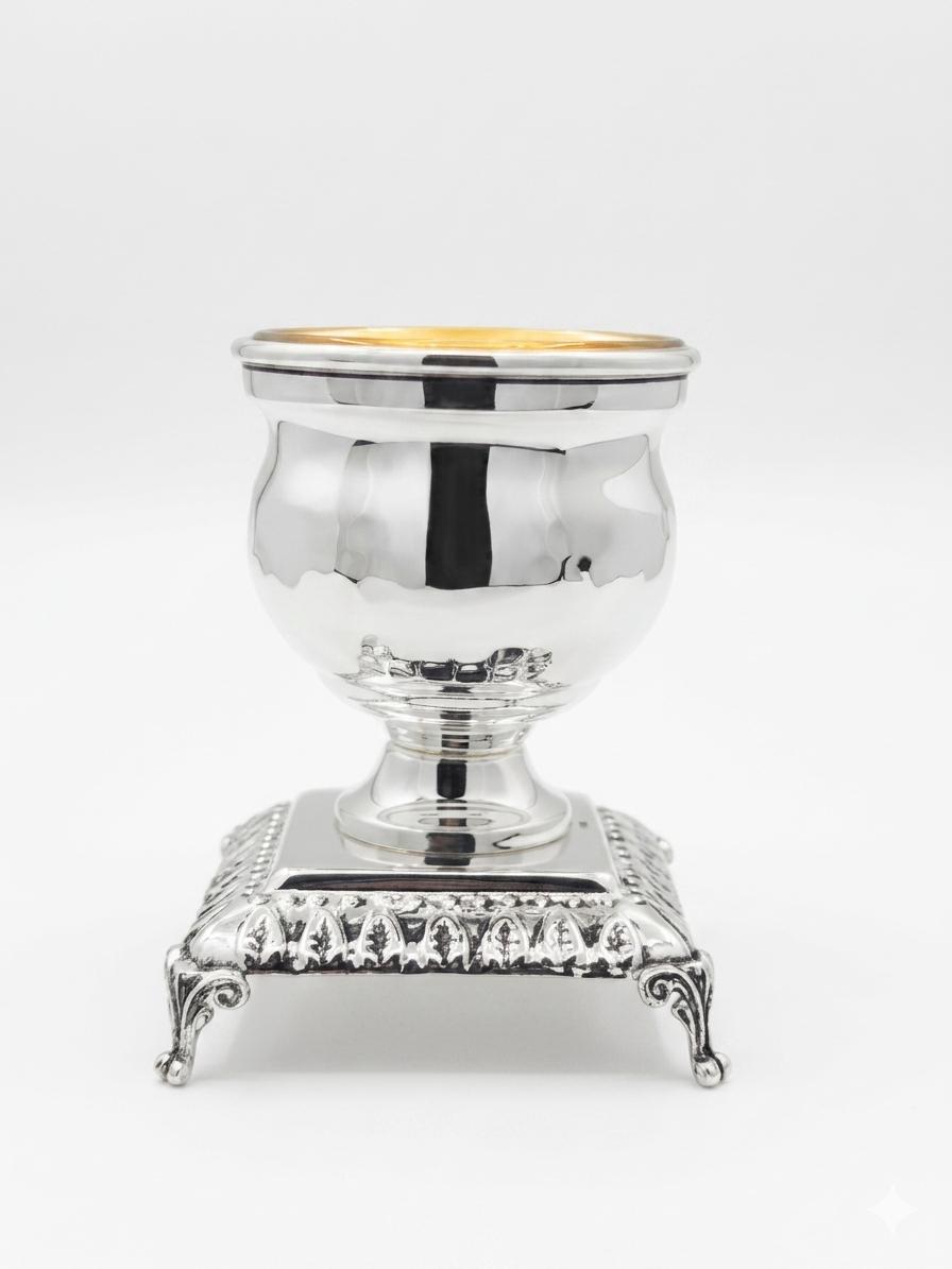 Silver and gold salt shaker cup on a white background