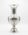 Silver vase with intricate designs on a white background