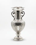 Silver vase with intricate designs on a white background