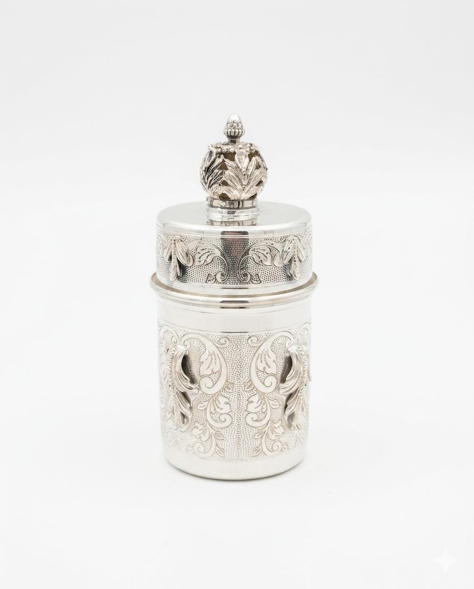 Decorative silver toothpick holder with wooden toothpicks on a white background