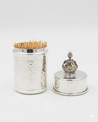 Silver toothpick holder with decorative top on a white background