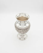 Silver vase with intricate patterns on a white background
