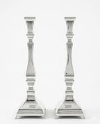 Two silver candlesticks on a white background