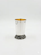 Silver kiddush cup with gold interior on a white background