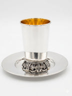 Silver kiddush cup with gold interior on a white background