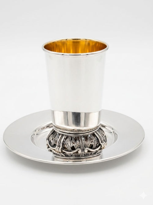 Silver kiddush cup with gold interior on a white background