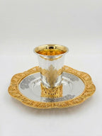 Silver and gold kiddush set on a white background