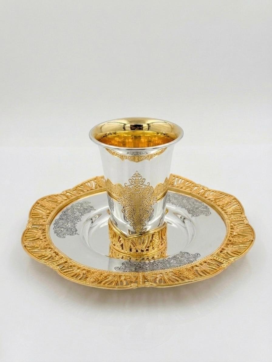Silver and gold kiddush set on a white background