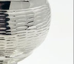 Silver and gold salt shaker cup on a white background