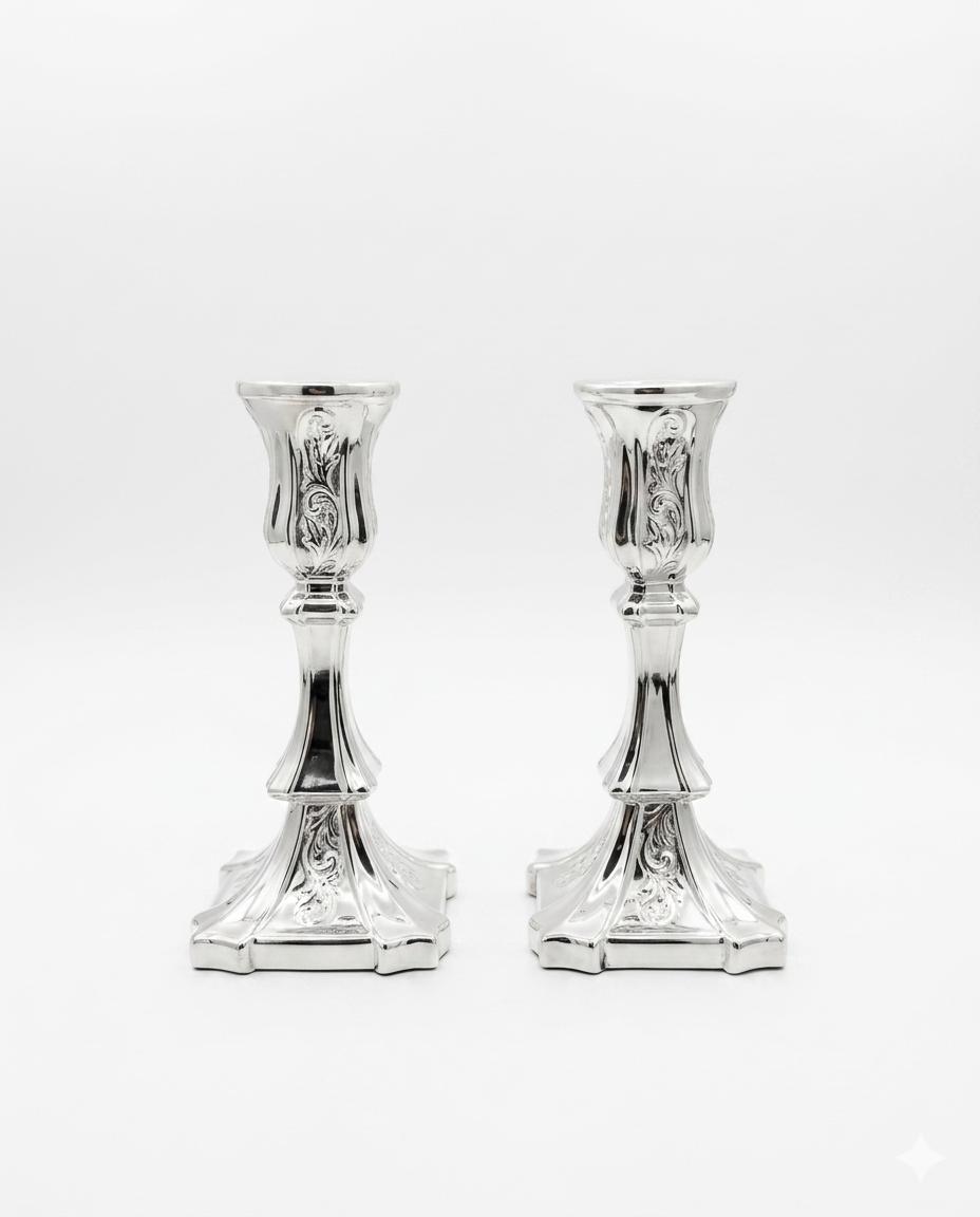 Pair of silver candlesticks on a white background
