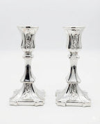 Pair of silver candlesticks on a white background