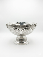 Decorative silver bowl and natla set with intricate engravings on a white background