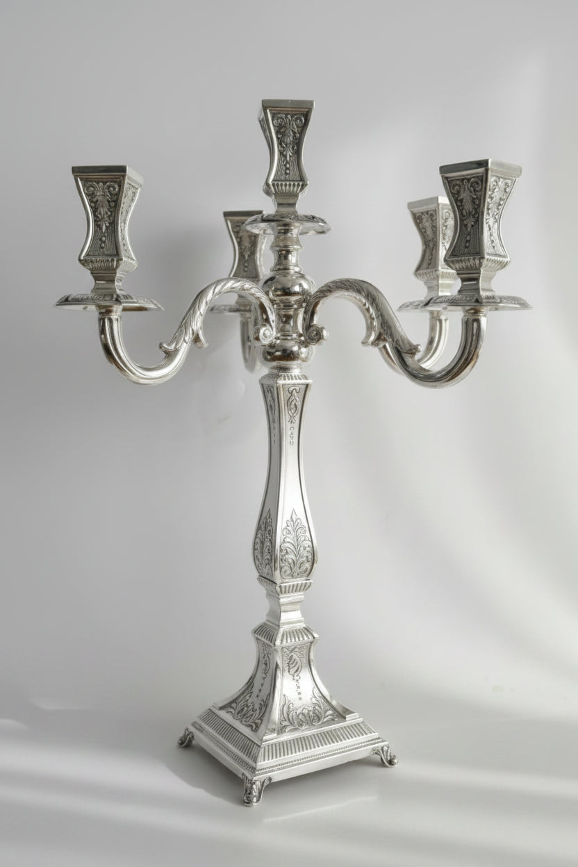 Silver candelabra with three candle holders on a white background