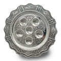 Decorative silver Seder plate with embossed design on a white background