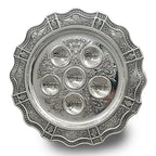 Decorative silver Seder plate with embossed design on a white background