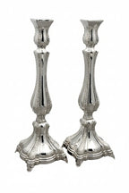 Two silver candlesticks on a white background