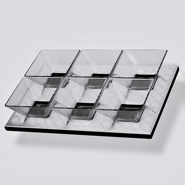 Clear glass serving tray with divided sections on a light gray background
