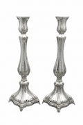 Two silver candlesticks on a white background