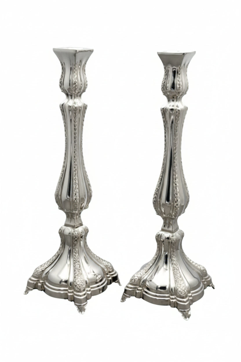 Two silver candlesticks on a white background