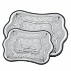 Two silver challah trays with embossed designs on a white background by hadad bros