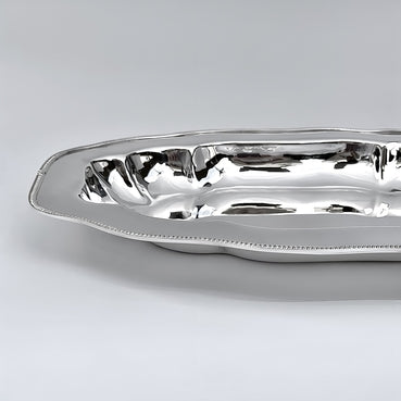 Silver serving dish on a light gray background