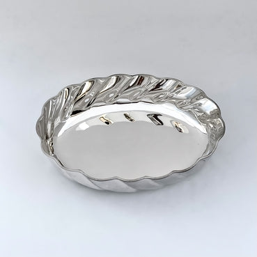 Silver bowl with wavy edge on a white background