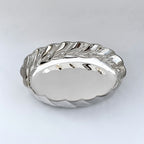 Silver bowl with wavy edge on a white background